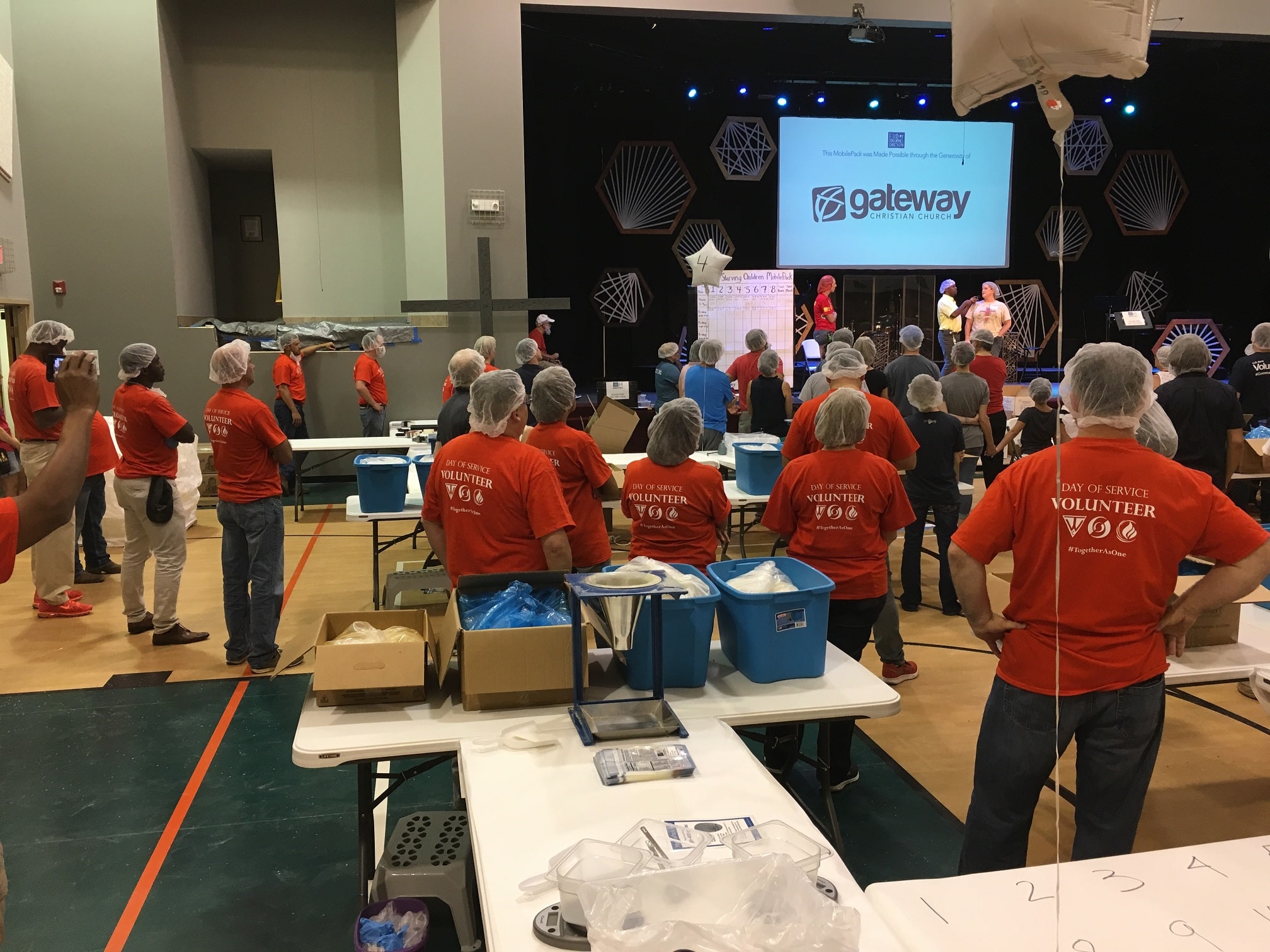 This image is of TW Constructors volunteering a day of service to make and hand out lunches for children in 2019